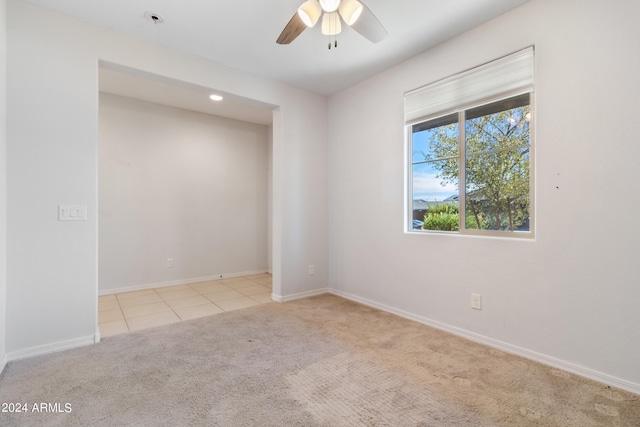 spare room with light carpet and ceiling fan