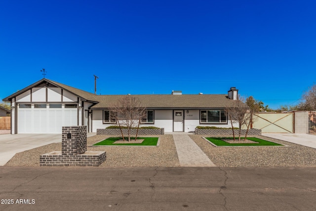 view of front of home with a gate, fence, concrete driveway, a shingled roof, and a garage