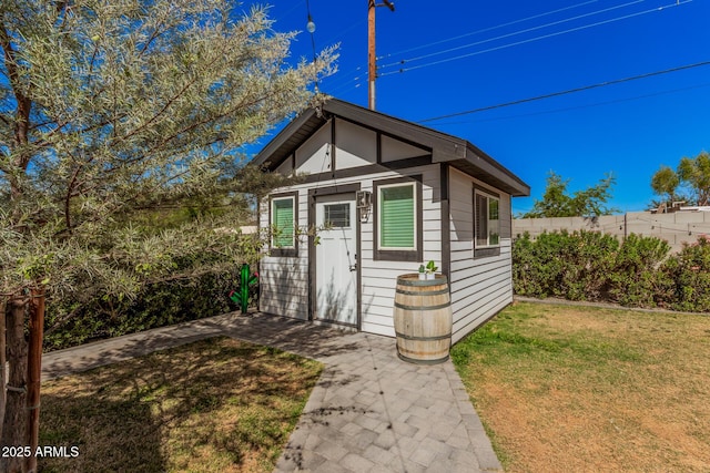 view of outdoor structure with an outbuilding and fence