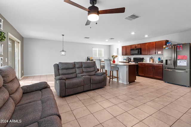 tiled living room with ceiling fan