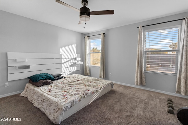 carpeted bedroom with multiple windows and ceiling fan