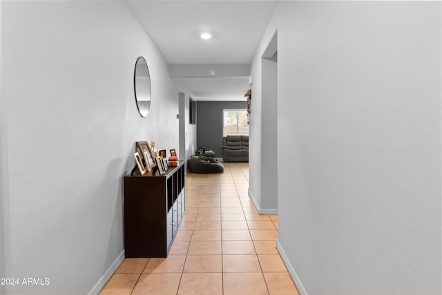 hall featuring light tile patterned floors