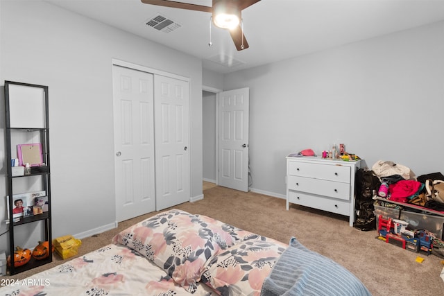 bedroom with ceiling fan, a closet, and light carpet