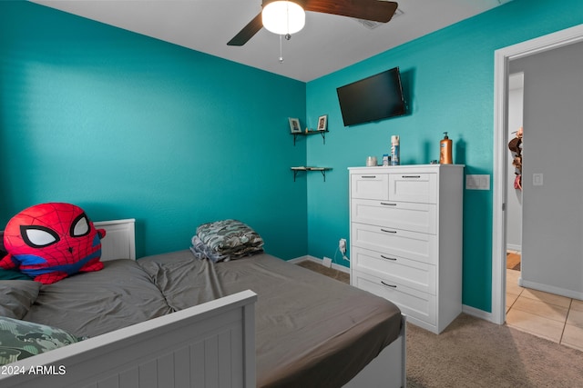 bedroom featuring ceiling fan and light carpet