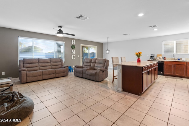 tiled living room featuring ceiling fan and sink