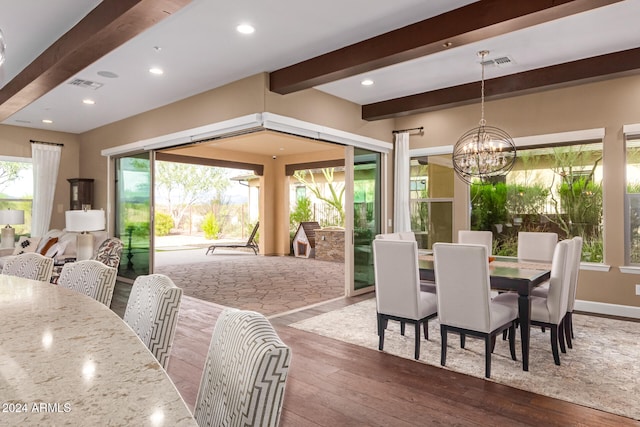 dining space with a chandelier, hardwood / wood-style flooring, and beam ceiling