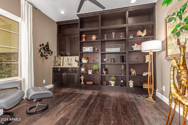 sitting room featuring dark wood-type flooring and ceiling fan