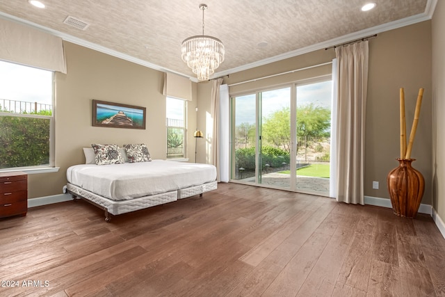 bedroom with access to outside, wood-type flooring, crown molding, and a notable chandelier