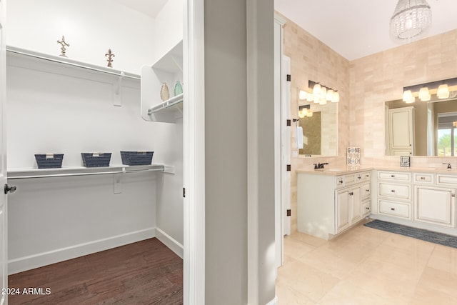 bathroom featuring tile walls, vanity, and wood-type flooring