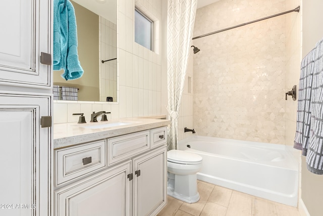 full bathroom featuring toilet, vanity, tile patterned floors, and shower / bathtub combination with curtain