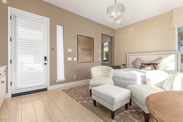 bedroom with light wood-type flooring and a notable chandelier