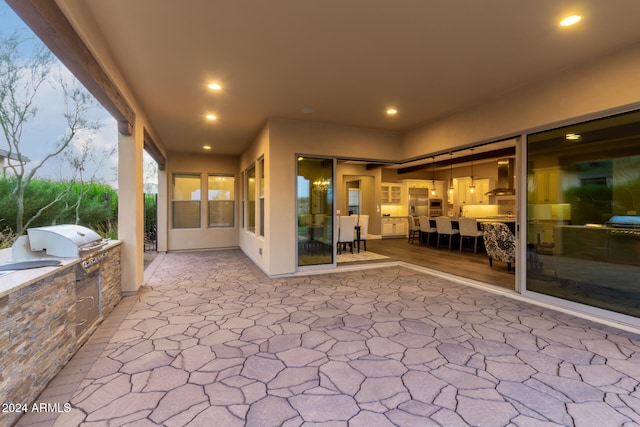 patio terrace at dusk with exterior kitchen