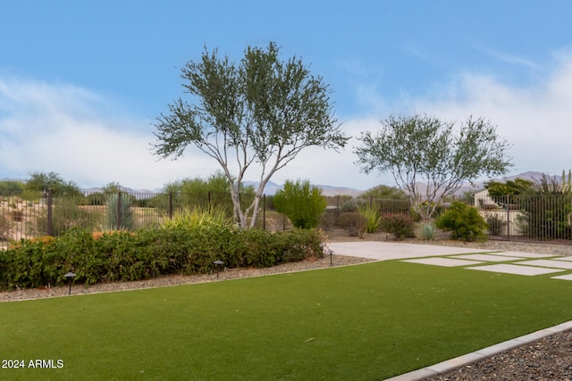 surrounding community featuring a lawn and a mountain view