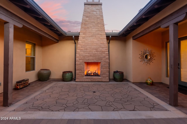 patio terrace at dusk with a large fireplace