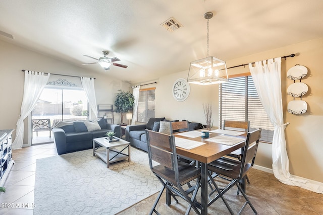 dining space with tile patterned flooring, a textured ceiling, vaulted ceiling, and ceiling fan