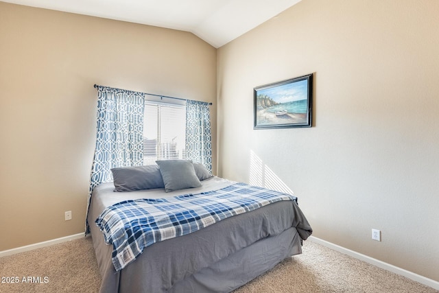 bedroom featuring vaulted ceiling and carpet