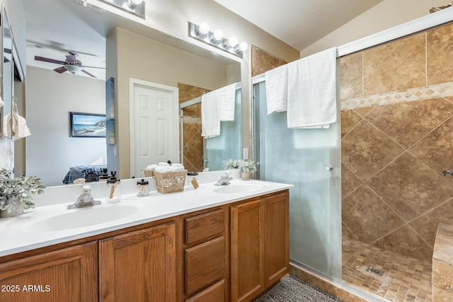 bathroom featuring ceiling fan, vanity, a shower with shower door, and lofted ceiling