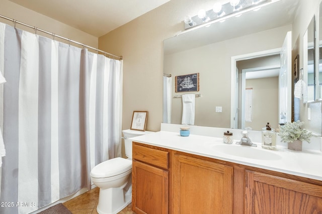 bathroom with vanity, tile patterned floors, and toilet