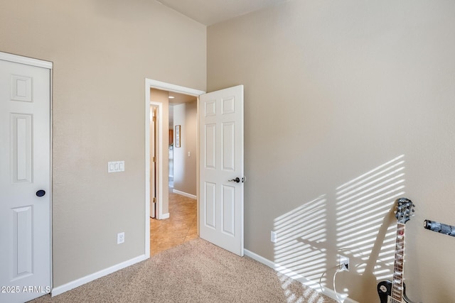 corridor featuring light colored carpet