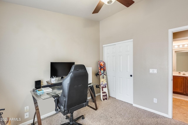 office featuring sink, light carpet, and ceiling fan