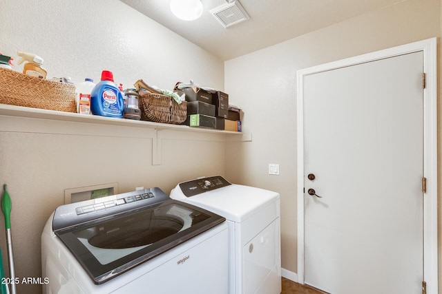 clothes washing area featuring washer and clothes dryer