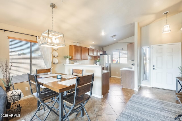 dining room with tile patterned flooring and lofted ceiling