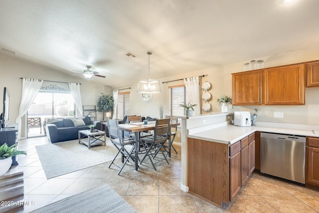 kitchen featuring dishwasher, pendant lighting, light tile patterned floors, and kitchen peninsula