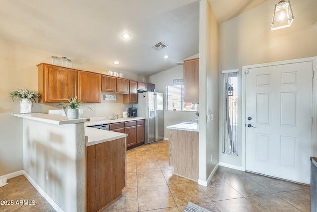 kitchen featuring stainless steel refrigerator with ice dispenser, lofted ceiling, light tile patterned floors, and kitchen peninsula