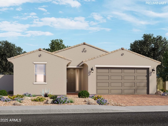 mediterranean / spanish-style home with a garage, decorative driveway, a tile roof, and stucco siding