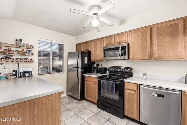 kitchen featuring ceiling fan, appliances with stainless steel finishes, and light tile patterned floors