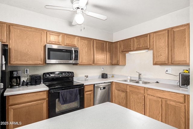 kitchen featuring appliances with stainless steel finishes, sink, and ceiling fan