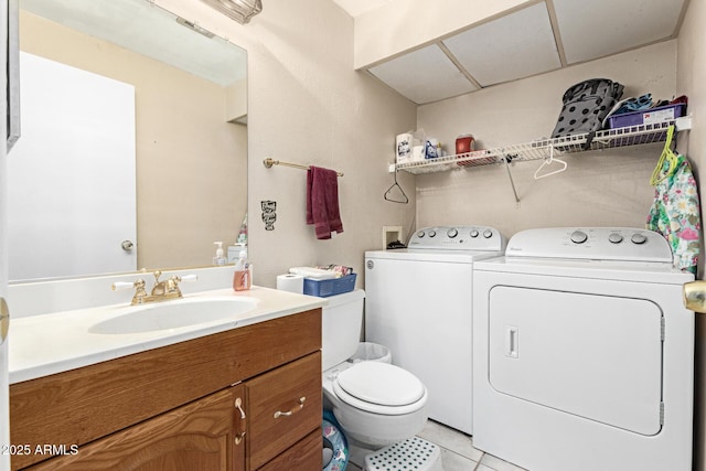 bathroom with vanity, toilet, tile patterned flooring, and washing machine and dryer