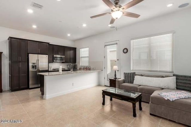 tiled living room featuring ceiling fan