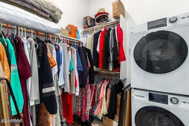 clothes washing area with stacked washer / dryer