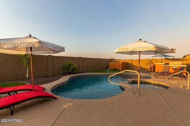 pool at dusk featuring a patio area