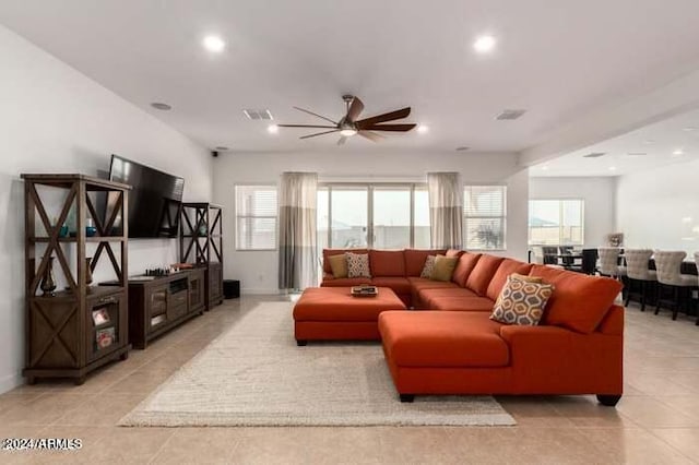 living room with ceiling fan and light tile patterned flooring