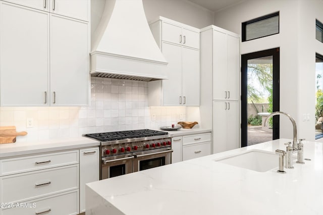 30600 N Pima Rd Unit 89, Scottsdale, AZ 85266 - kitchen with white cabinetry, double oven range, a sink, premium range hood, and backsplash