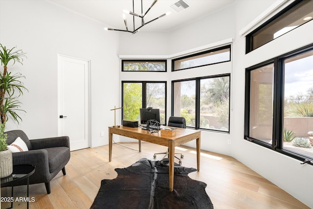 30600 N Pima Rd Unit 89, Scottsdale, AZ 85266 - home office featuring light wood-style flooring, a notable chandelier, visible vents, and a towering ceiling
