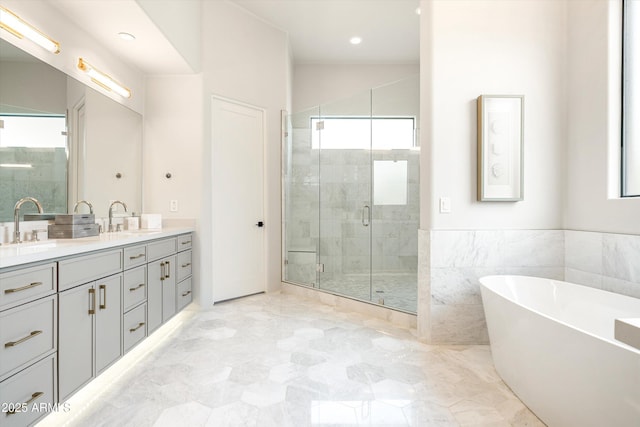 30600 N Pima Rd Unit 89, Scottsdale, AZ 85266 - full bathroom featuring double vanity, a shower stall, a freestanding bath, marble finish floor, and a sink