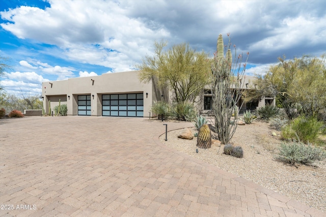 30600 N Pima Rd Unit 89, Scottsdale, AZ 85266 - pueblo-style home featuring an attached garage, decorative driveway, and stucco siding