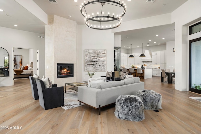 30600 N Pima Rd Unit 89, Scottsdale, AZ 85266 - living area featuring recessed lighting, a tile fireplace, light wood-style floors, and an inviting chandelier