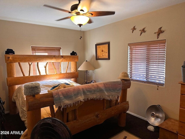 bedroom featuring a ceiling fan and baseboards