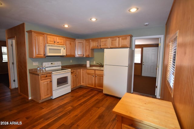 kitchen with dark wood-type flooring, recessed lighting, white appliances, and a sink