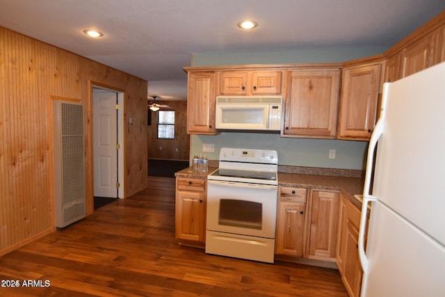 kitchen featuring recessed lighting, white appliances, a heating unit, and dark wood finished floors