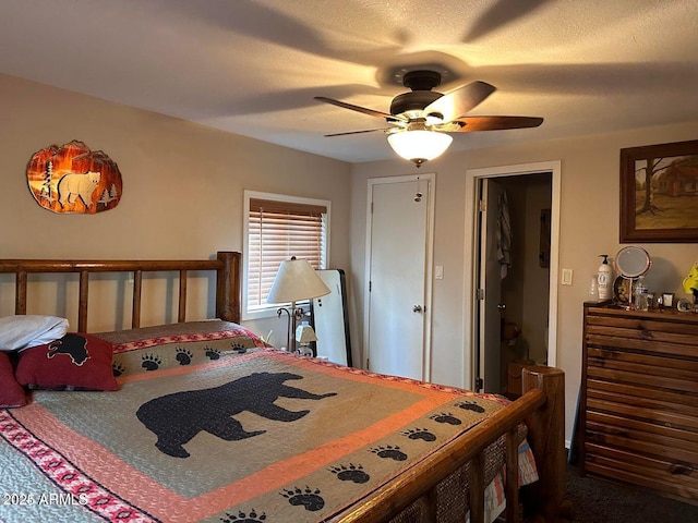 bedroom with ceiling fan and a textured ceiling