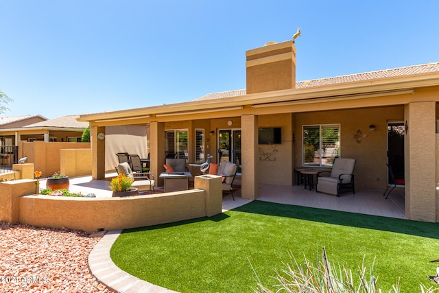 back of house featuring outdoor lounge area, a lawn, and a patio area