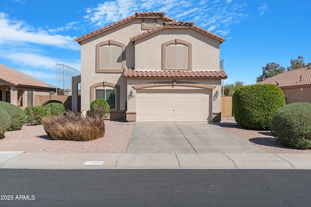 mediterranean / spanish house featuring stucco siding, an attached garage, driveway, and a tiled roof