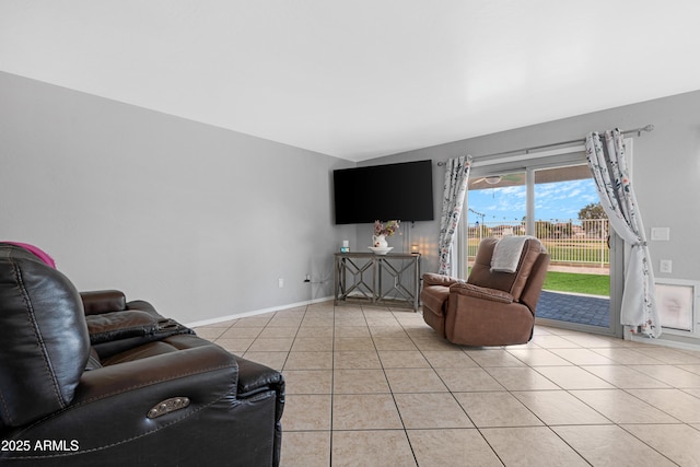 living area featuring light tile patterned flooring and baseboards