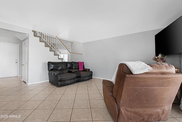 living room with light tile patterned flooring, stairway, and baseboards