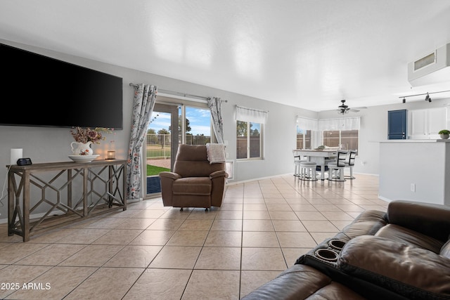 living room with visible vents, baseboards, a ceiling fan, and tile patterned flooring